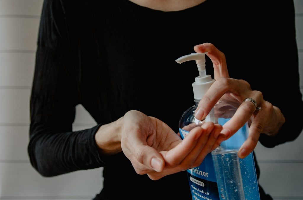 A woman using hand sanitiser
