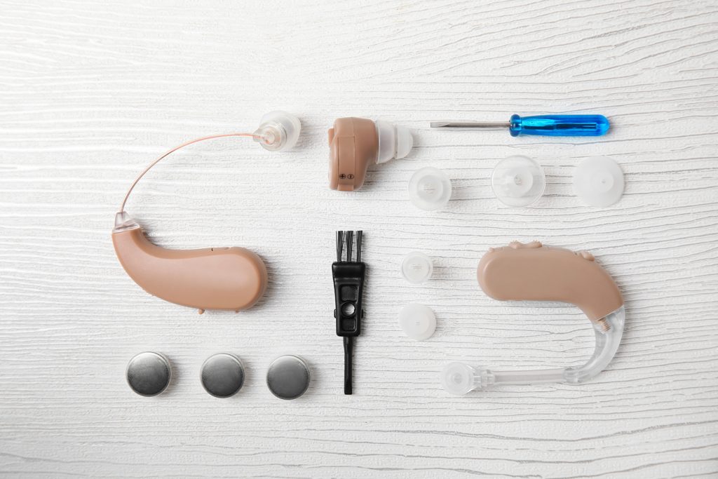 Hearing aids laid out with everything needed to clean it