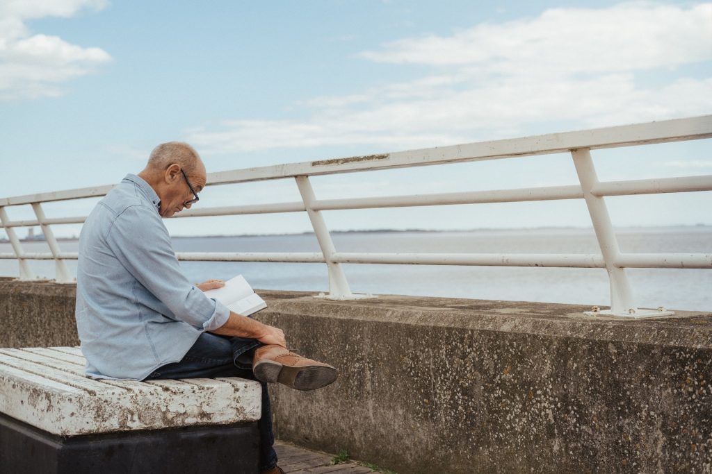 Old man reading alone Hearing loss and depression with north london audiologists