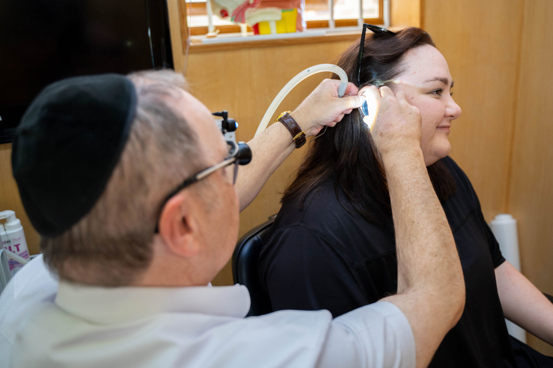 Earwax removal on patient