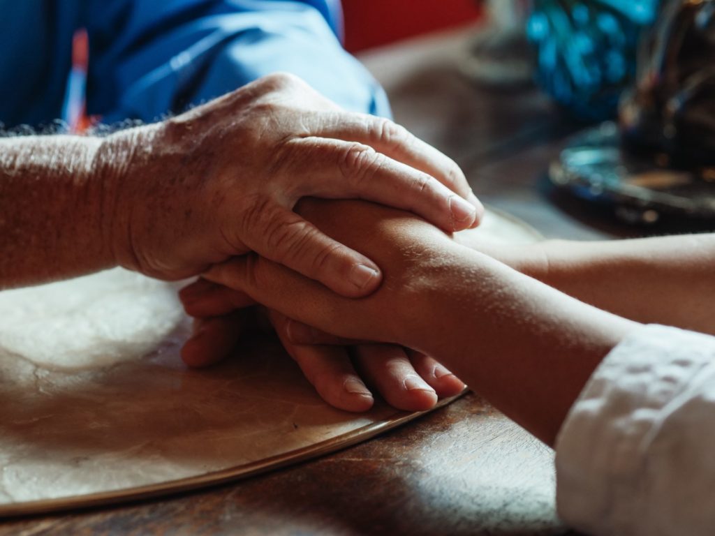 Someone comforting another person suffering from dementia
